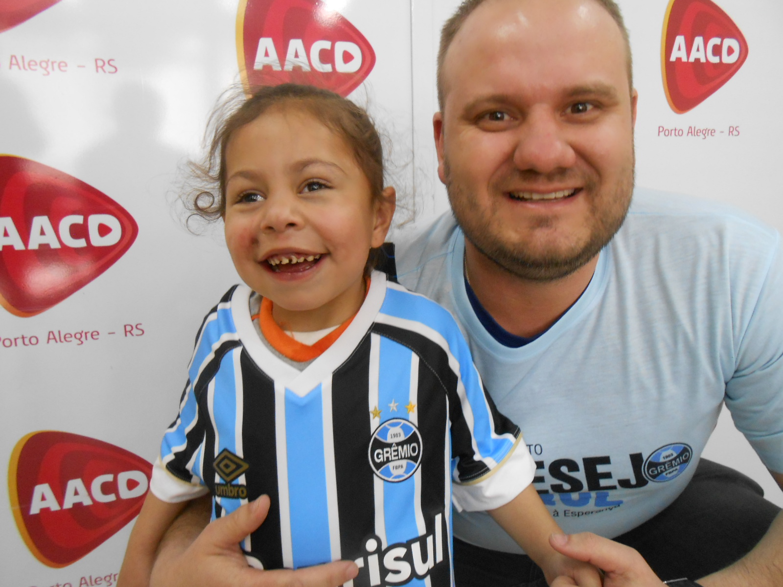 Basta olhar nas fotos e identificar a alegria de Izabelle de apenas 4 anos ao ganhar sua camiseta tricolor. A menina a vestiu com muito orgulho e ainda beijou o distintivo do Grêmio. A ação contou com a participação do voluntário Alisson de Figueredo Machado